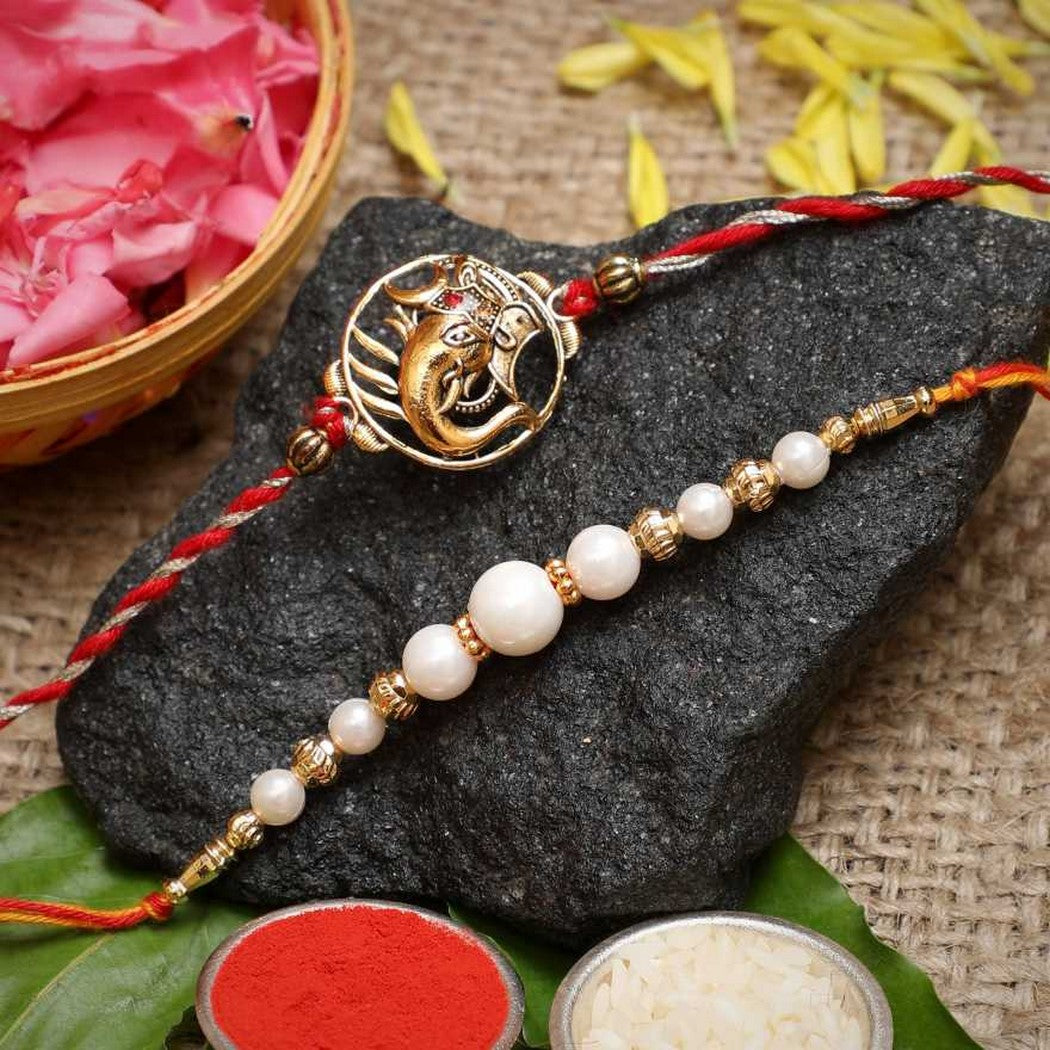 eCraftIndia Set of 2 Lord Ganesha and Beautiful Pearls Designer Rakhis with Roli Chawal Pack