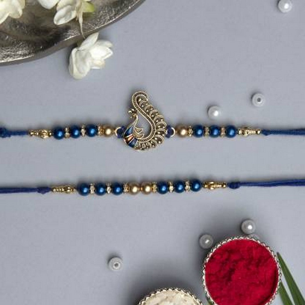 eCraftIndia Set of 2 Blue & Golden Pearls and Peacock Designer Rakhis with Roli Chawal Pack 1