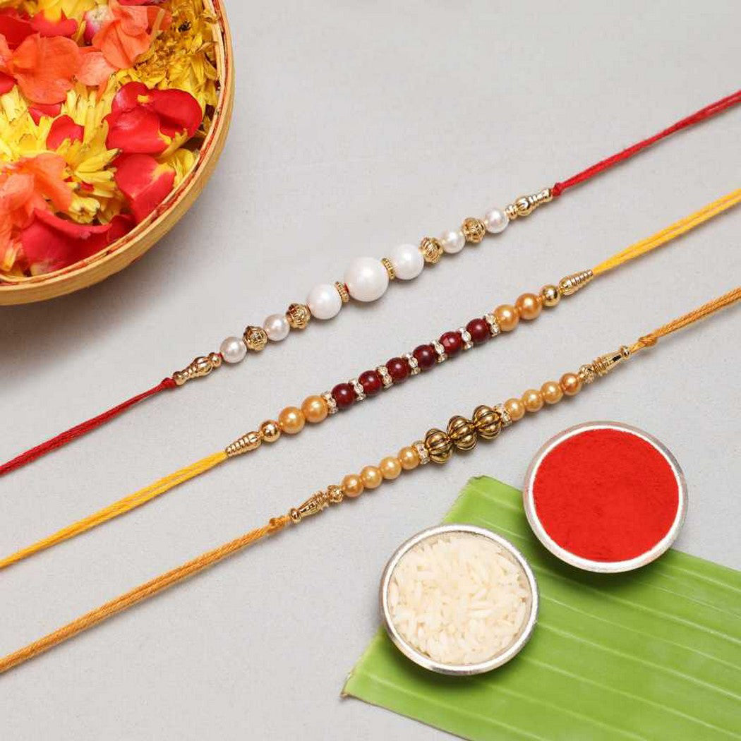 eCraftIndia White, Red & Golden Set of 3 Pearl Rakhis 1