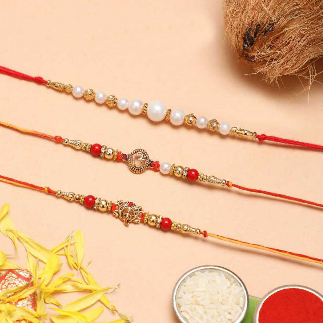 eCraftIndia Set of 3 Golden, Red & White Pearls, Om Symbol, Lord Ganesha Religious Designer Rakhis with Roli Chawal Pack 1