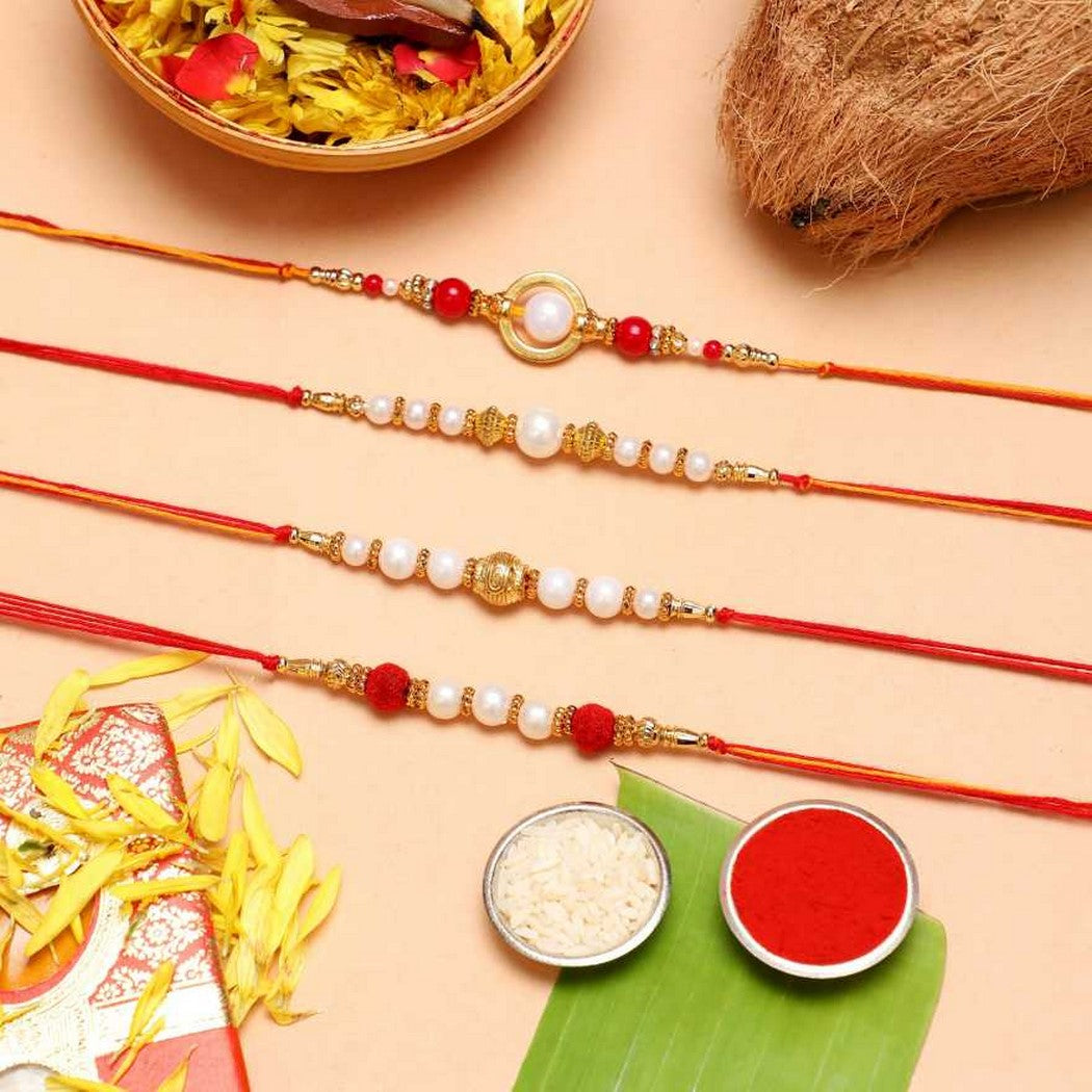 eCraftIndia Set of 4 Red, Golden White Pearls Rakhis with Roli Chawal Pack