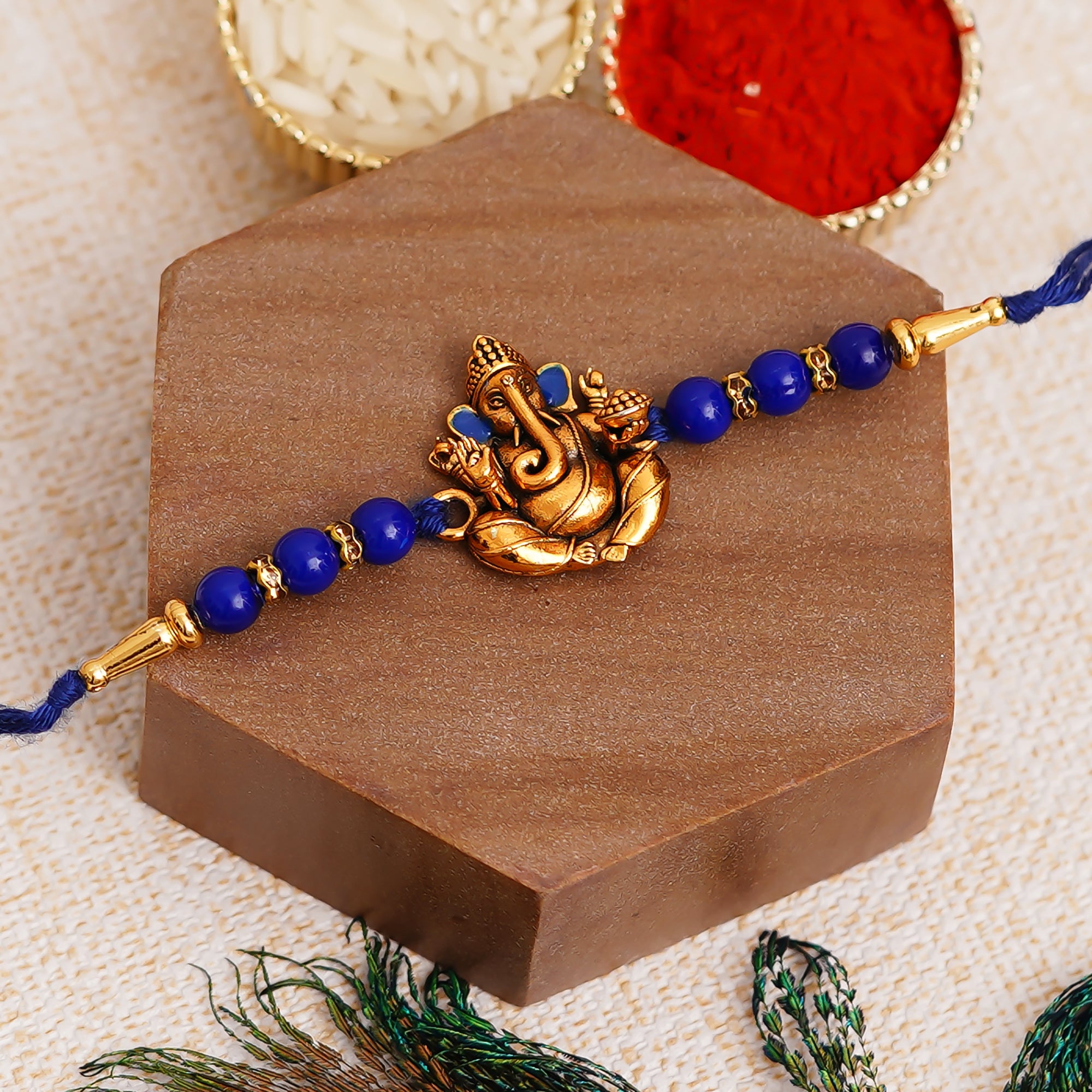 Golden Lord Ganesha Blue Pearl Rakhi and Roli Chawal Pack