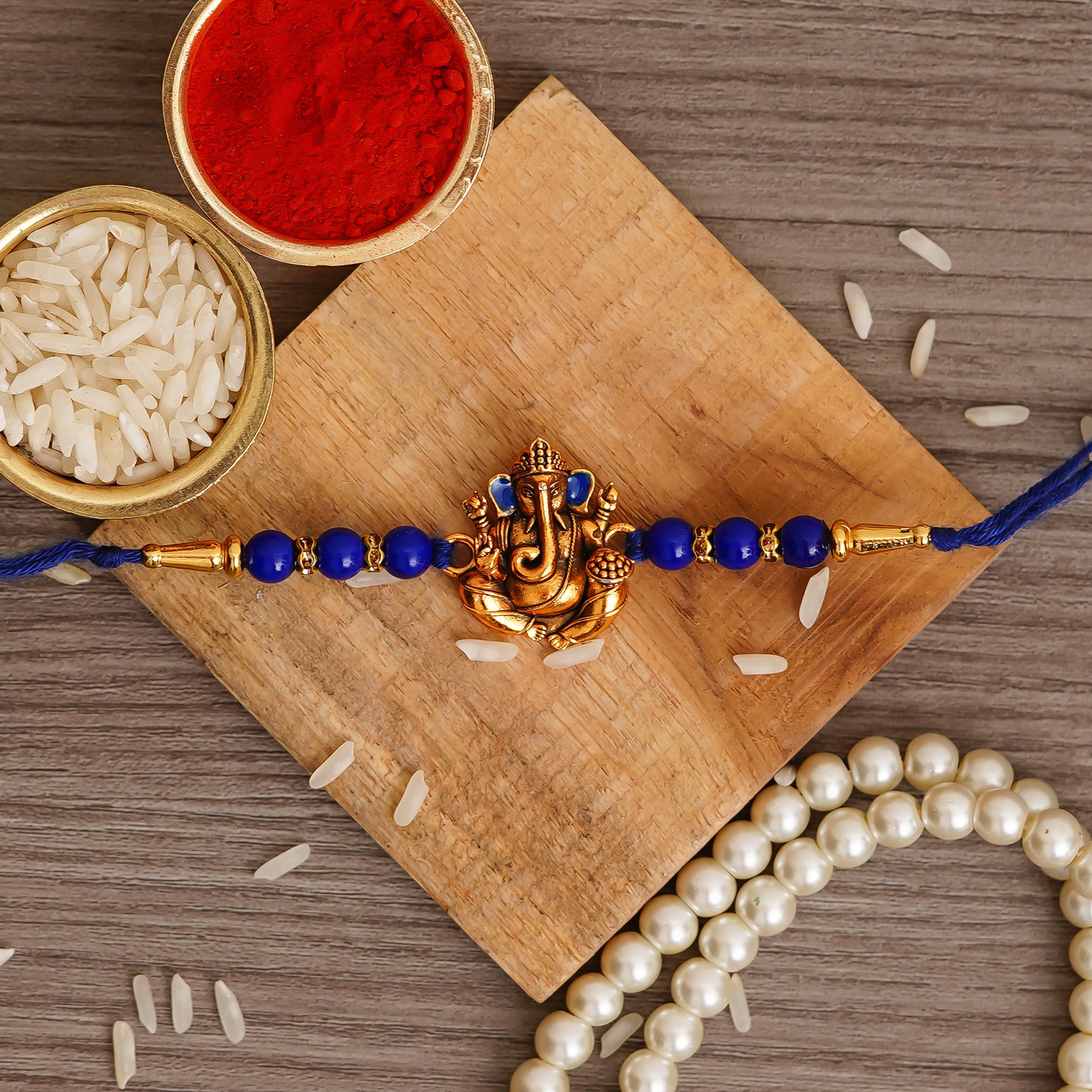 Golden Lord Ganesha Blue Pearl Rakhi and Roli Chawal Pack 1