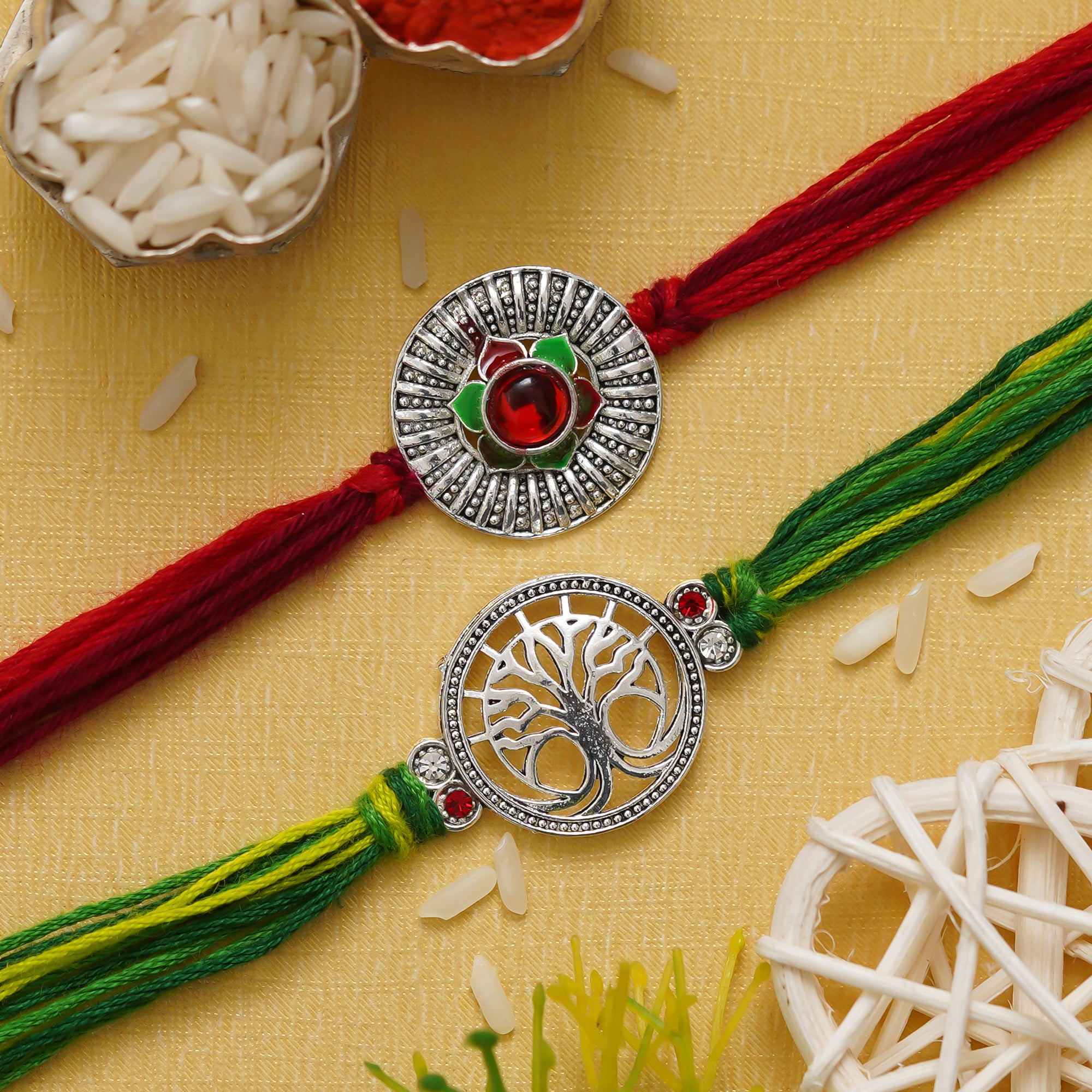 eCraftIndia Set of 2 Silver Flower and Tree Designer Rakhis with Red, Green Threads, and Roli Chawal Pack