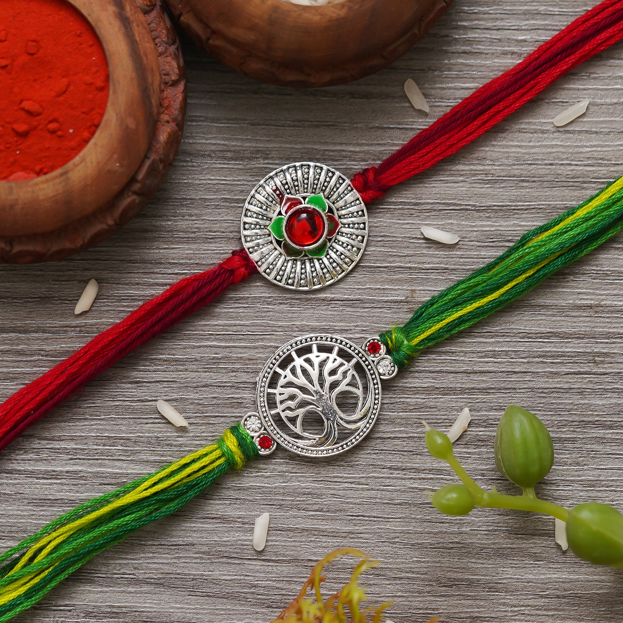 eCraftIndia Set of 2 Silver Flower and Tree Designer Rakhis with Red, Green Threads, and Roli Chawal Pack 1