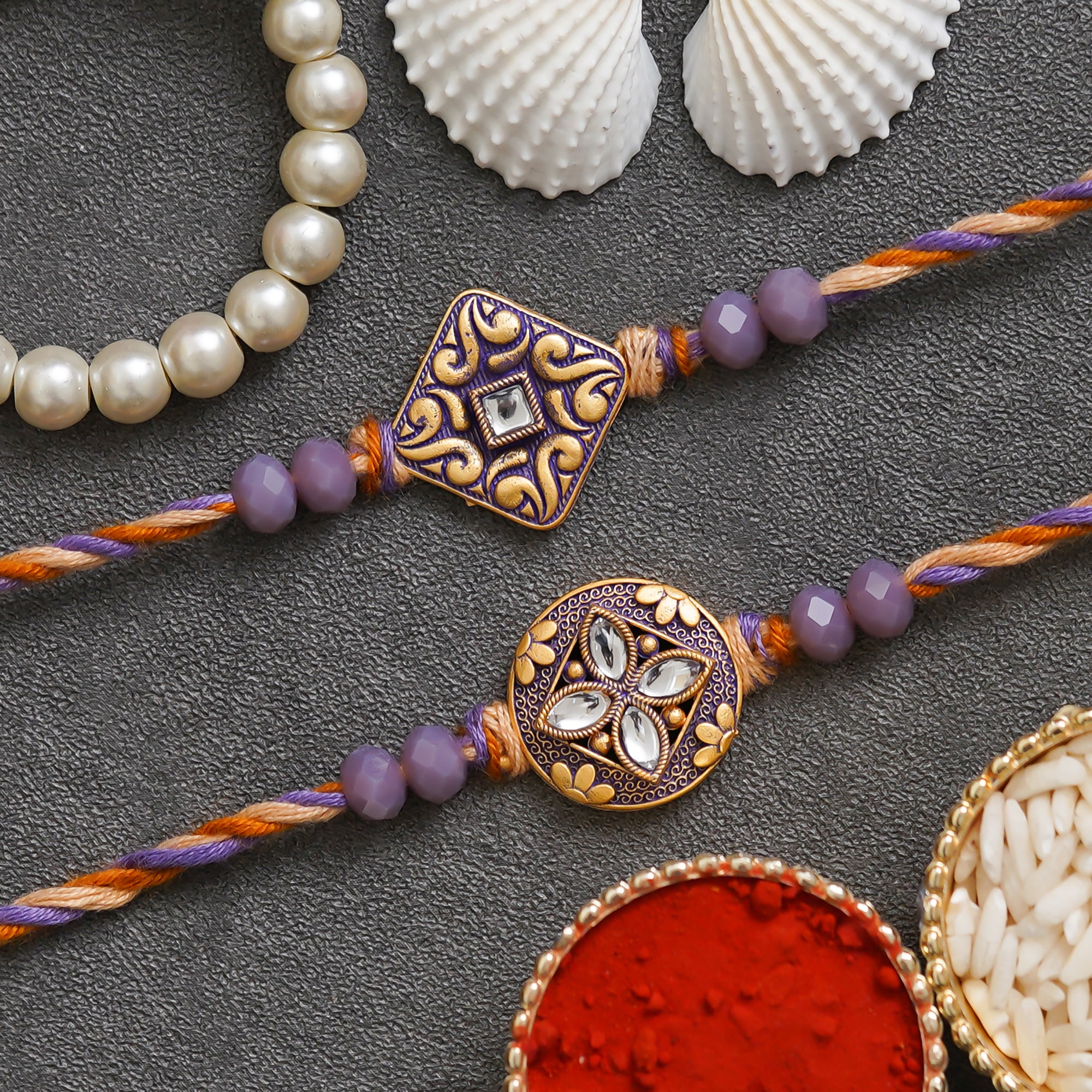 eCraftIndia Purple and Golden Set of 2 Precious Stone Designer Rakhis with Roli Chawal Pack