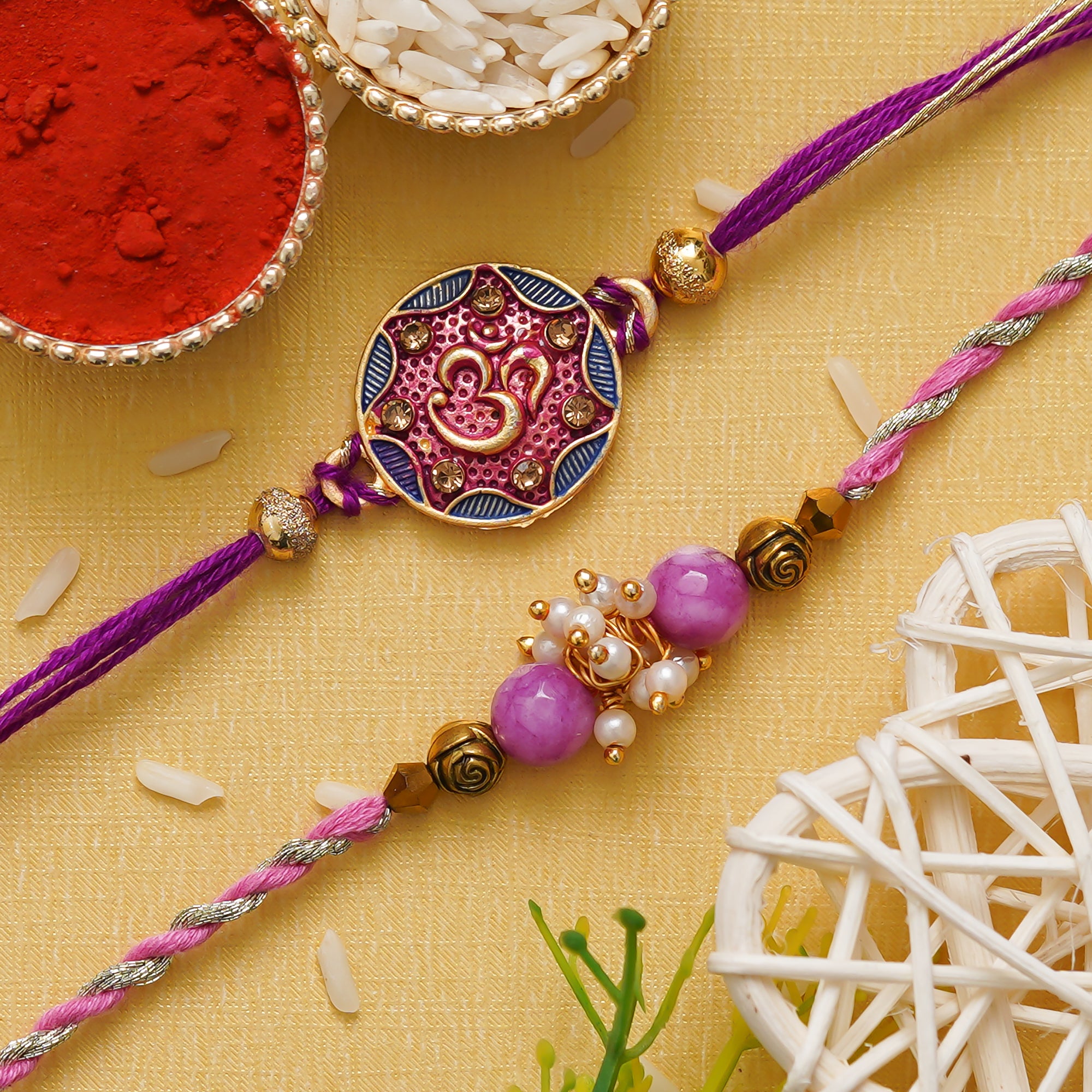 eCraftIndia Purple & Golden Set of 2 Om Symbol and Pearl Designer Rakhis with Roli Chawal Pack 1