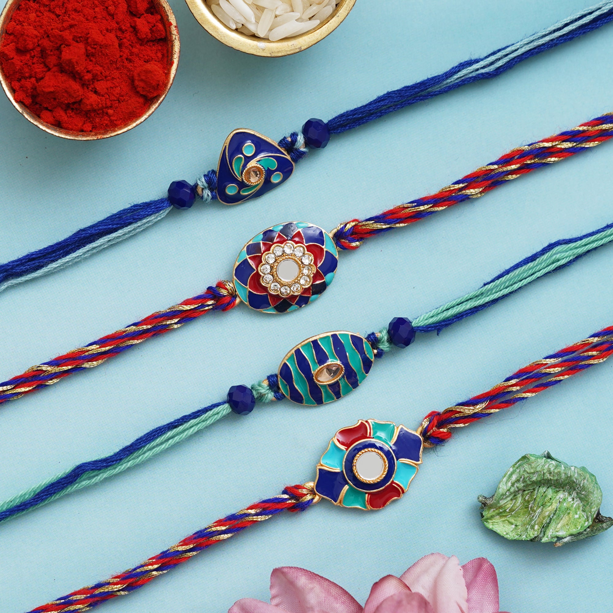 Set of 4 Blue, Red Floral Designer Rakhis with Roli Chawal Pack