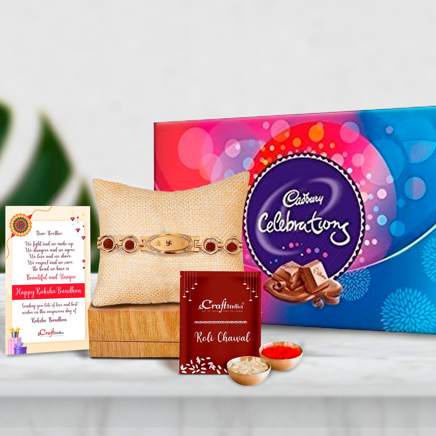 Designer Bracelet Religious Rakhi with Cadbury Celebrations Gift Pack of 7 Assorted Chocolates and Roli Chawal Pack, Best Wishes Greeting Card