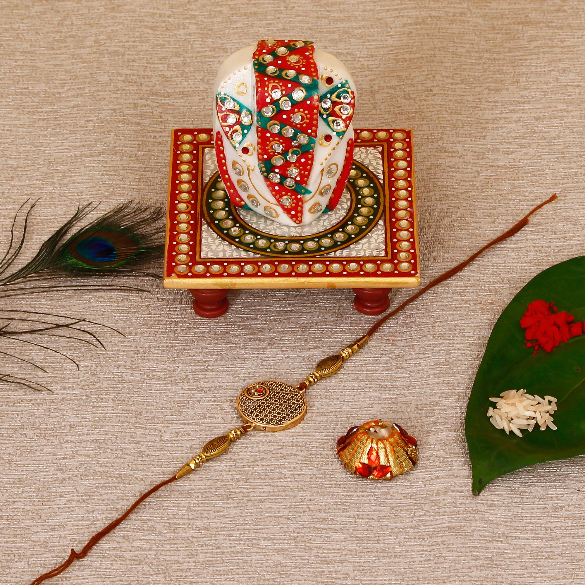 Designer Rakhi with Lord Ganesha on Kundan Studded Marble Chowki and Roli Tikka Matki