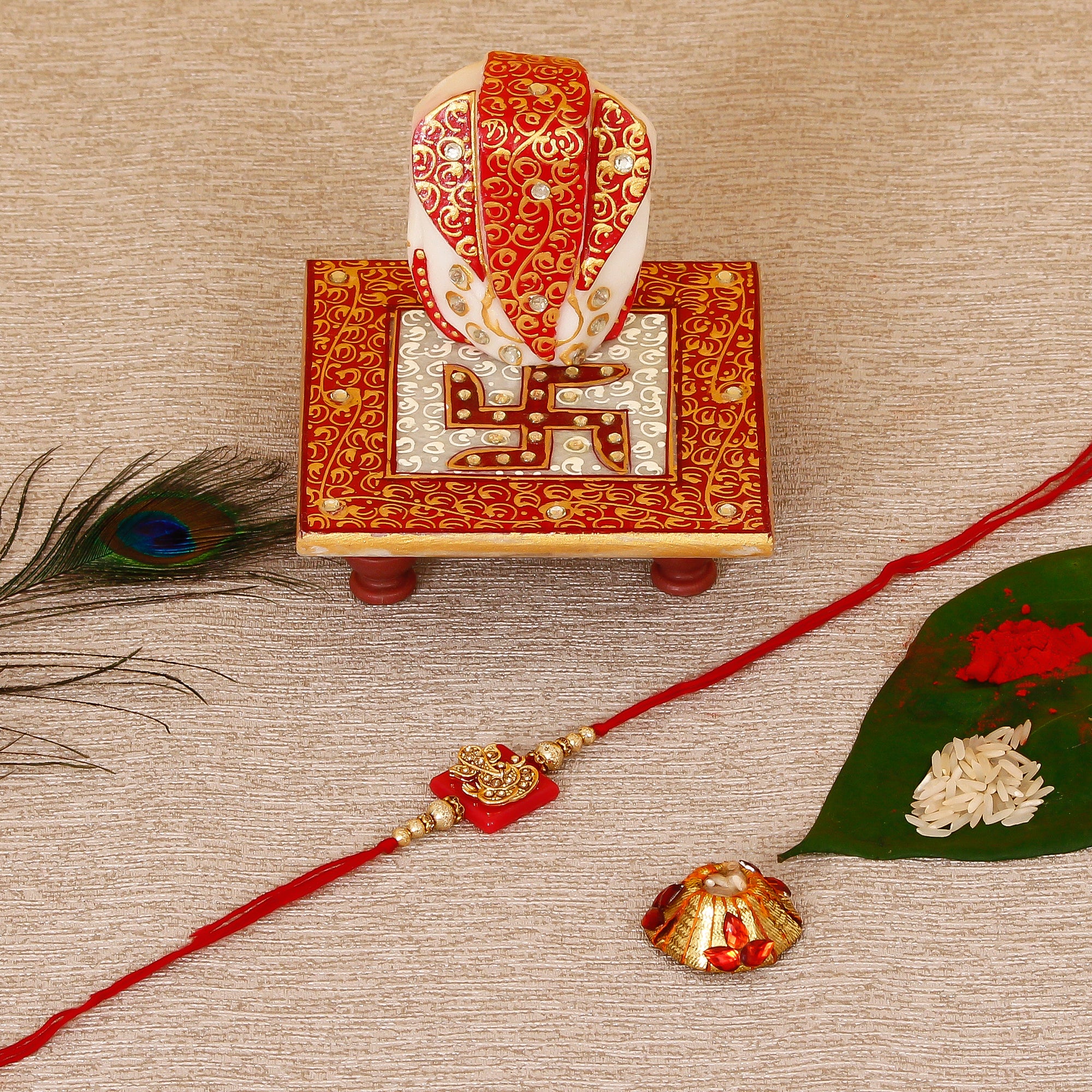 Designer Religious Ganesha Rakhi with Ridhi Sidhi Marble chowki and Roli Tikka Matki