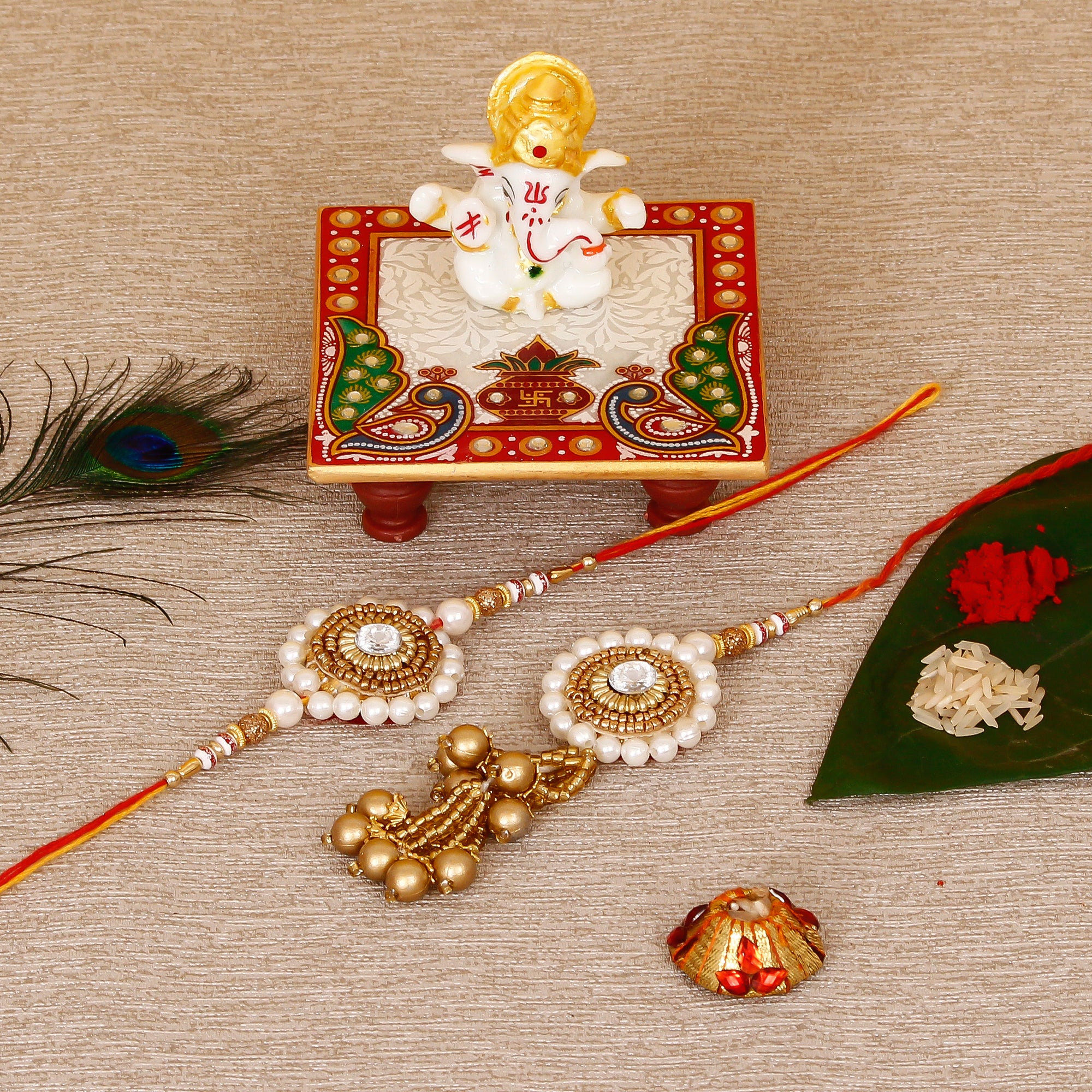 Designer Bhaiya Bhabhi Rakhi with Lord Ganesha Marble Chowki and Roli Tikka Matki
