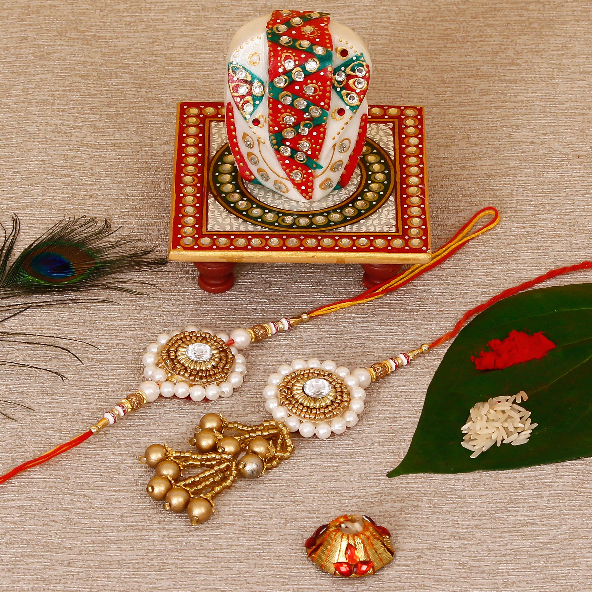 Designer Bhaiya Bhabhi Rakhi with Lord Ganesha on Kundan Studded Marble Chowki and Roli Tikka Matki