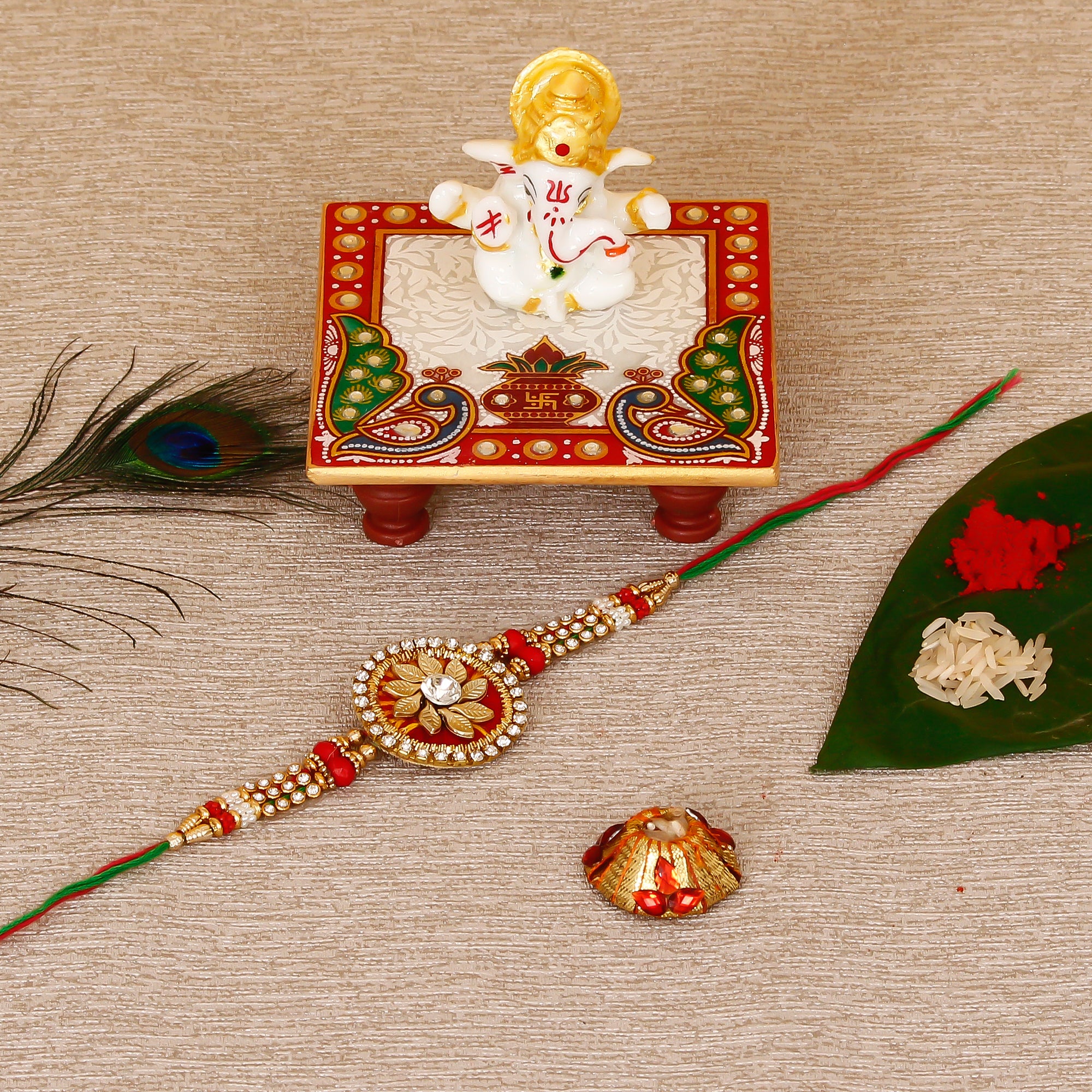 Designer Rakhi with Lord Ganesha Marble Chowki and Roli Tikka Matki