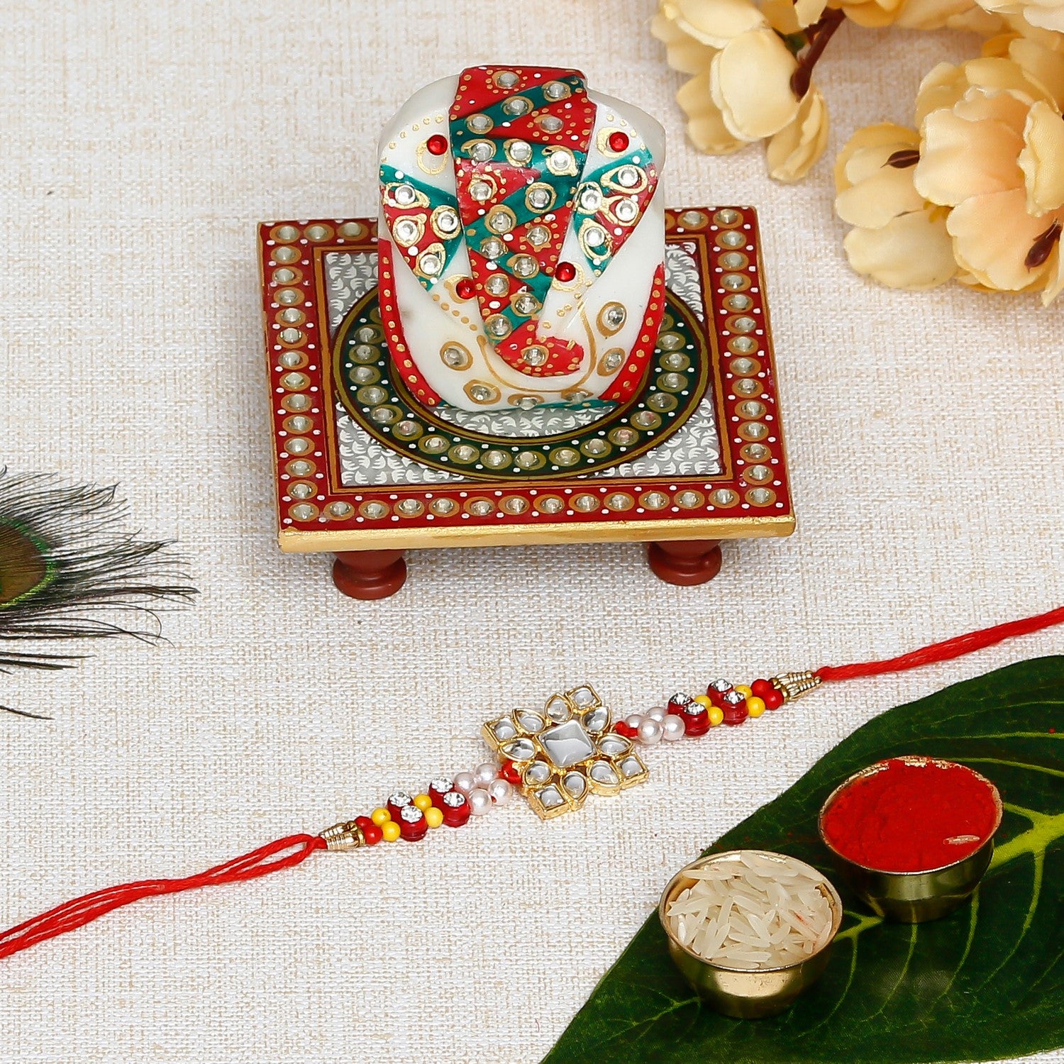 Designer Stone Work Rakhi with Lord Ganesha on Kundan Studded Marble Chowki and Roli Chawal Pack