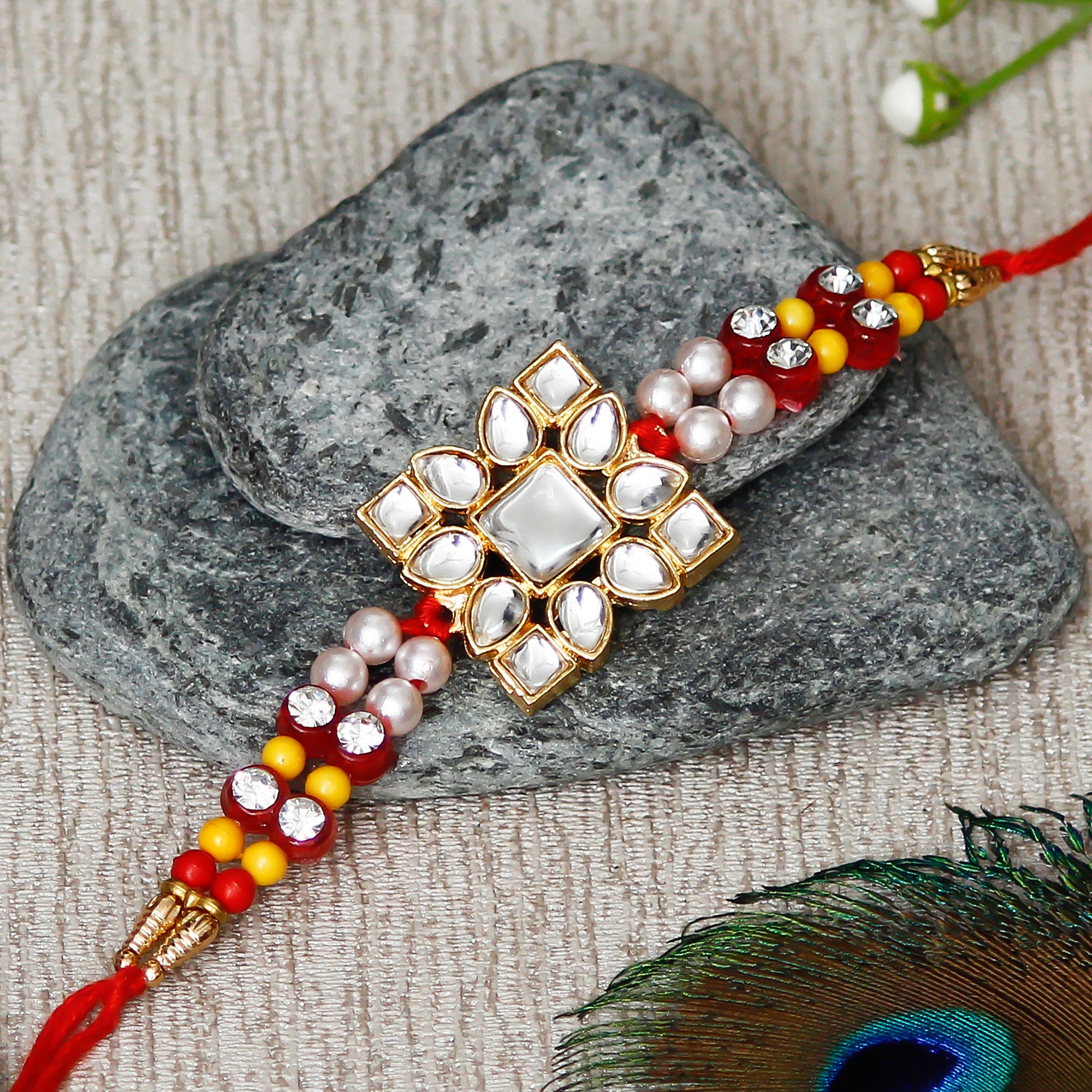 Designer Stone Work Rakhi with Lord Ganesha on Kundan Studded Marble Chowki and Roli Chawal Pack 1