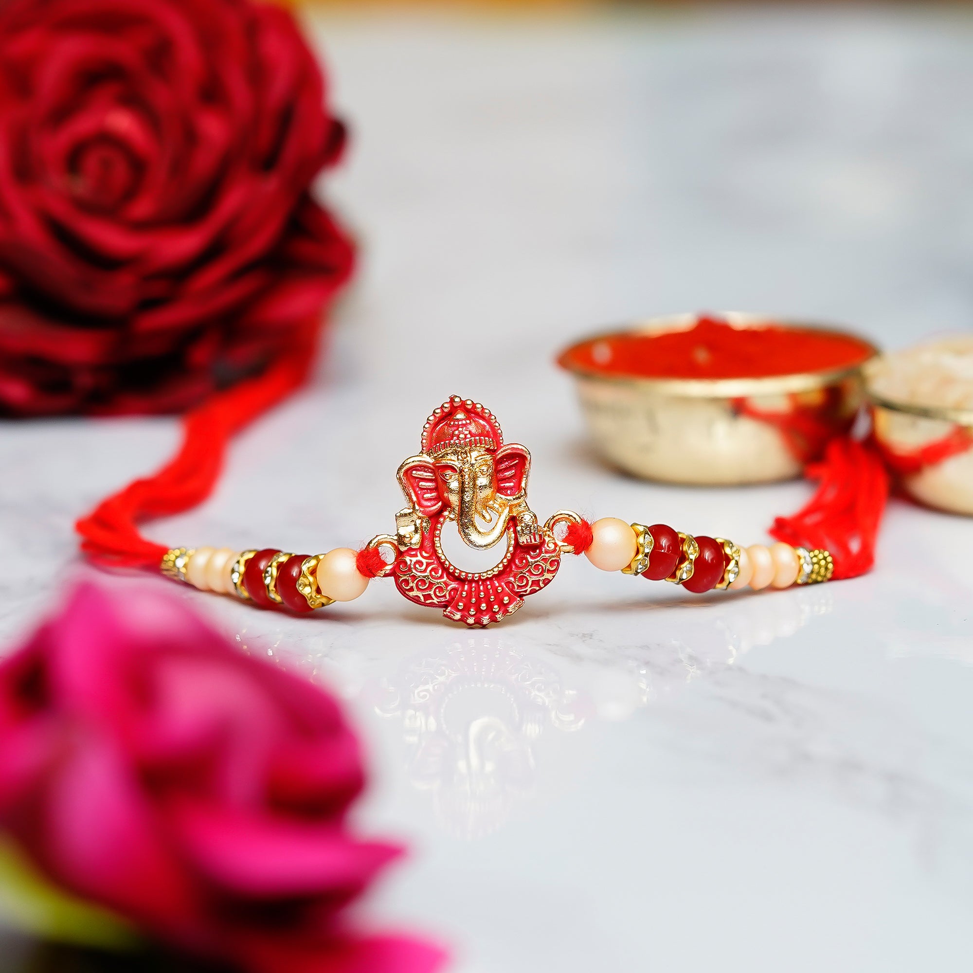 Designer Ganesha Rakhi with Lord Ganesha on Kundan Studded Marble Chowki and Roli Chawal Pack 1