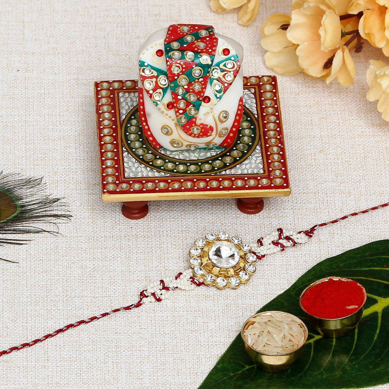 Designer  Handcrafted Rakhi with Lord Ganesha on Kundan Studded Marble Chowki and Roli Chawal Pack