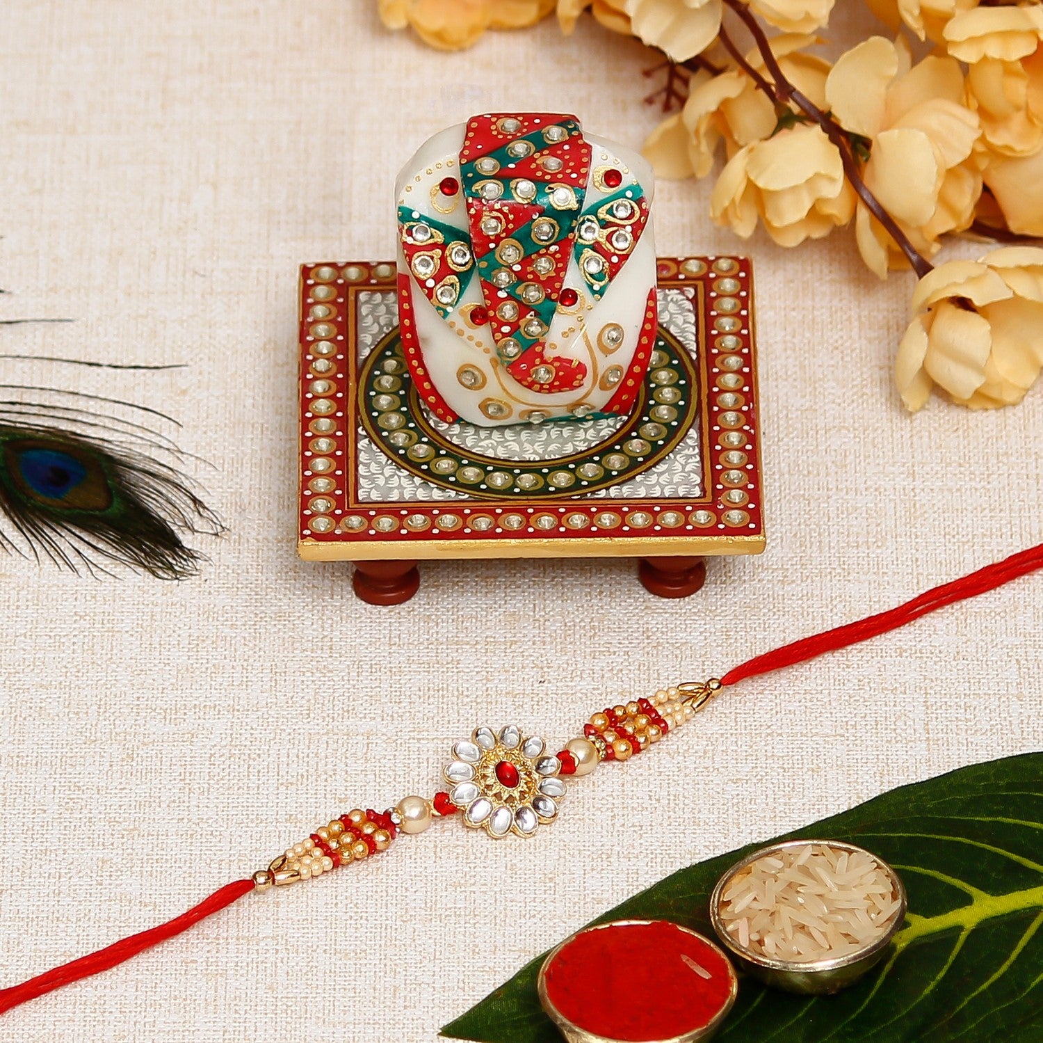 Desginer Rakhi with Lord Ganesha on Kundan Studded Marble Chowki and Roli Chawal Pack