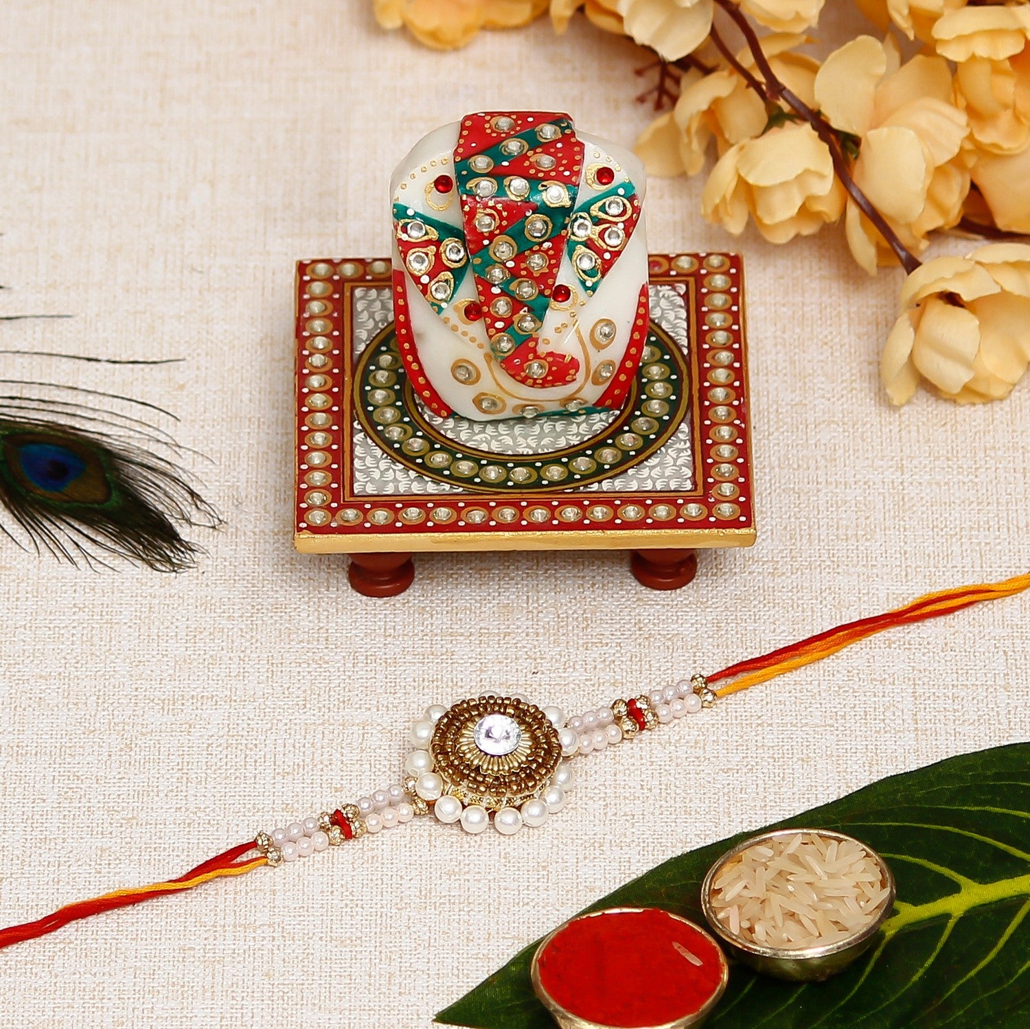 Desginer Stone and Pearl Rakhi with Lord Ganesha on Kundan Studded Marble Chowki and Roli Chawal Pack